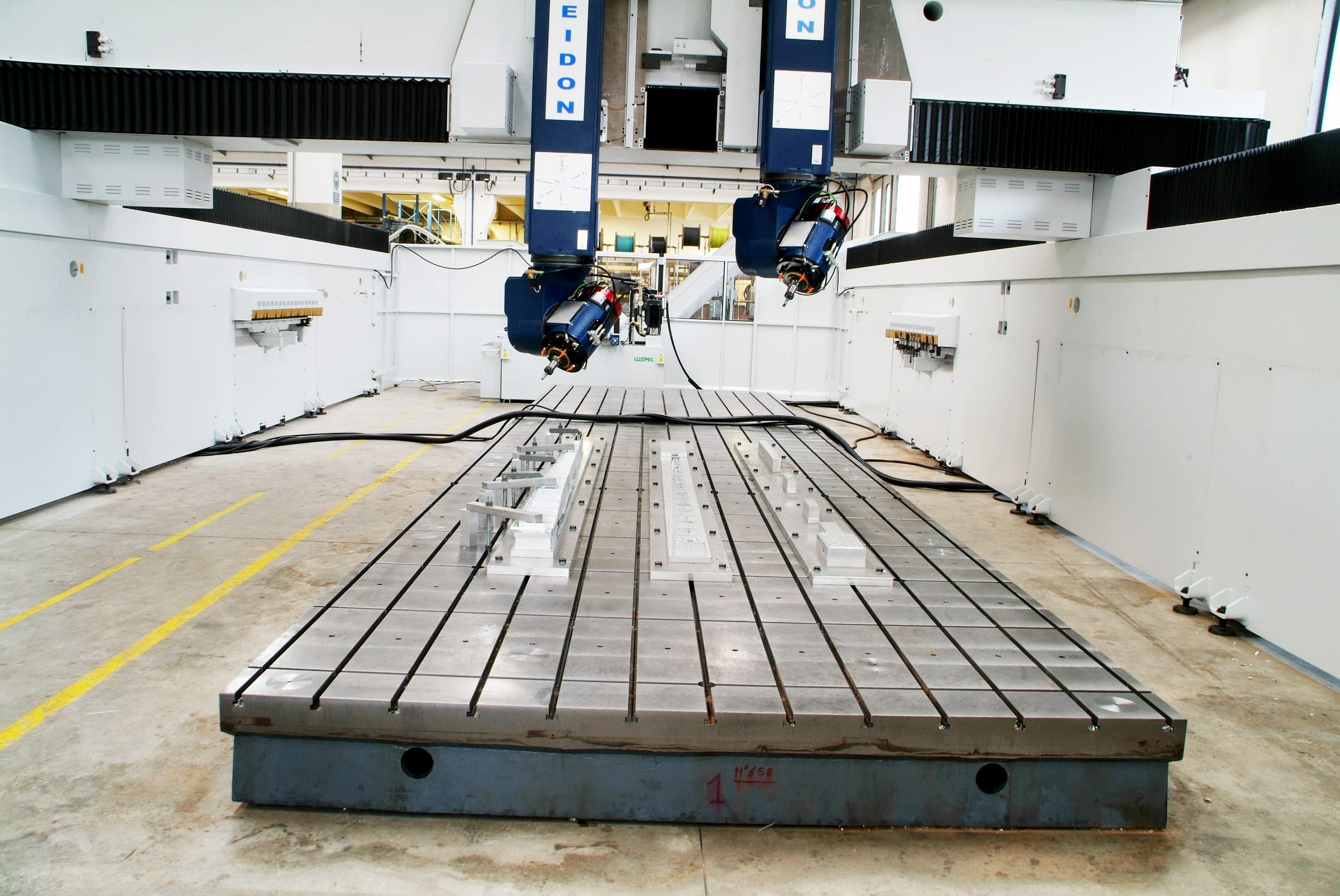 CMS 5-axis gantry machining center with two heads over a long T-slot table