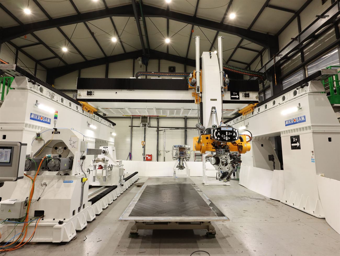 Mikrosam Taurus gantry automated fiber and tape placement machine laying up an aerospace part